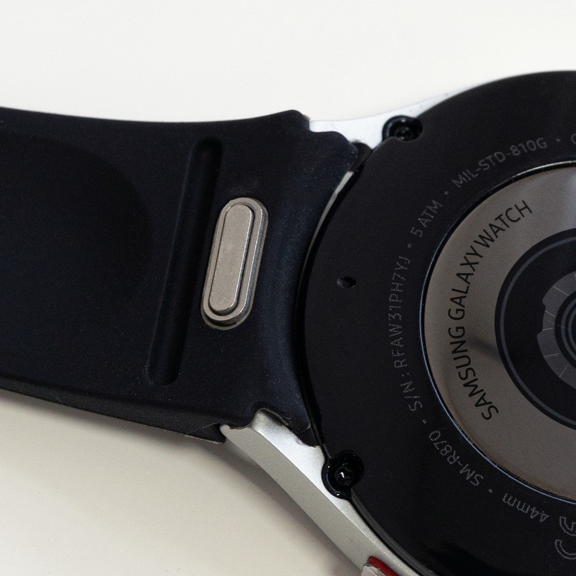 Silicone Strap 'One Push', black, on a watch, 3/4 rear view